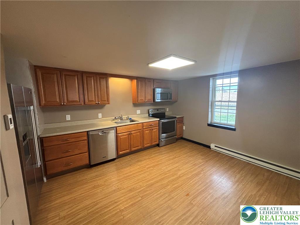654 Youngs Hill Road Easton, PA 18040 - Photo 11 of 36 a kitchen with stainless steel appliances granite countertop a stove a sink and a refrigerator