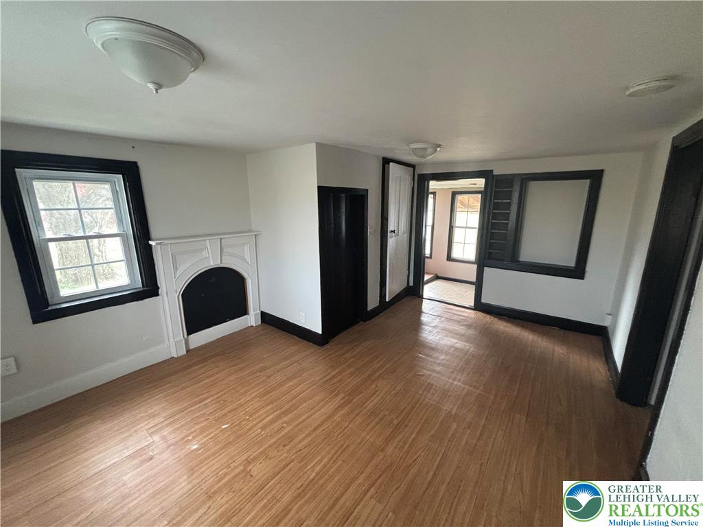 654 Youngs Hill Road Easton, PA 18040 - Photo 14 of 36 a view of an empty room with wooden floor and a window
