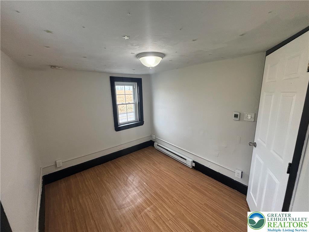 654 Youngs Hill Road Easton, PA 18040 - Photo 17 of 36 an empty room with wooden floor and windows