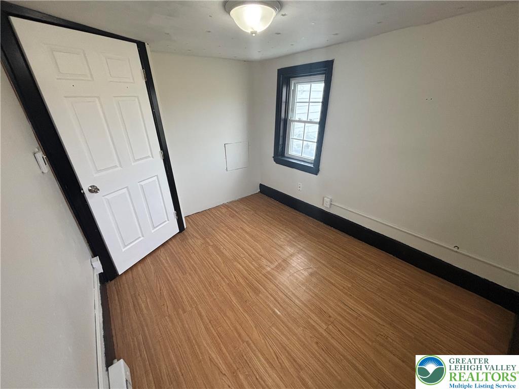 654 Youngs Hill Road Easton, PA 18040 - Photo 18 of 36 a view of an empty room with wooden floor and a window