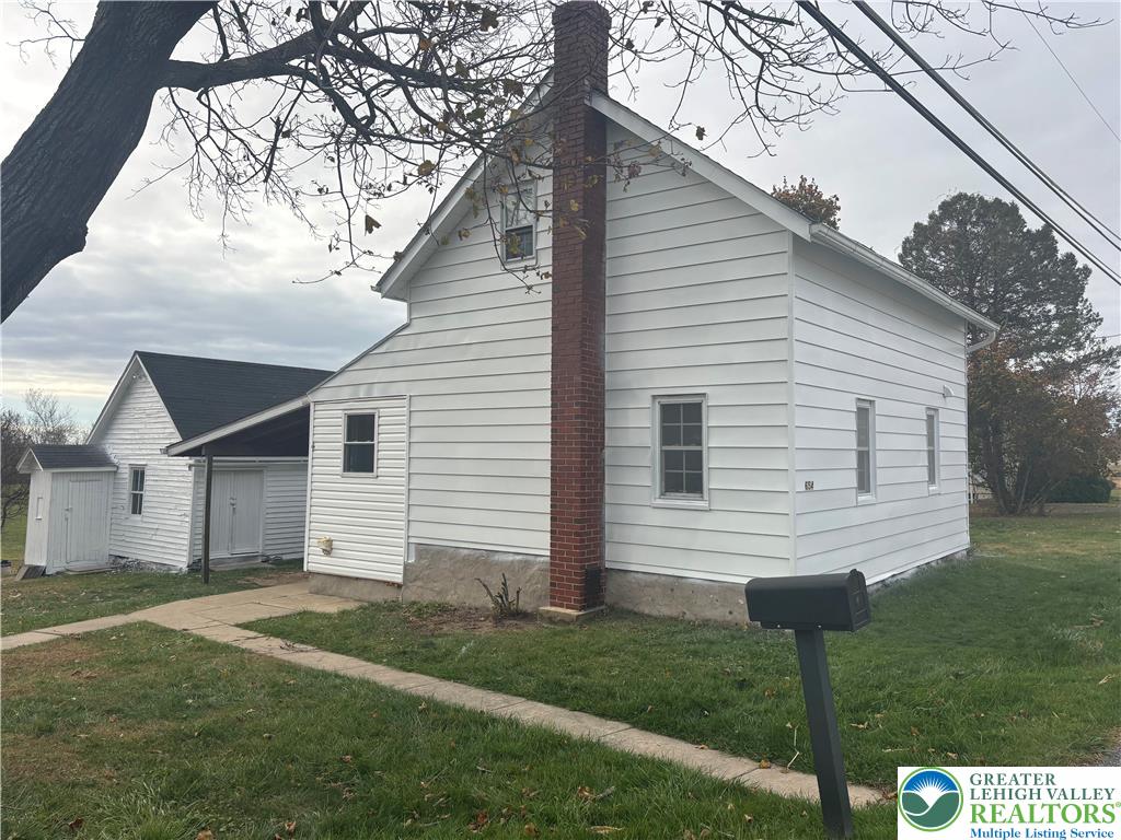 654 Youngs Hill Road Easton, PA 18040 - Photo 5 of 36 a view of a white house next to a yard with big trees