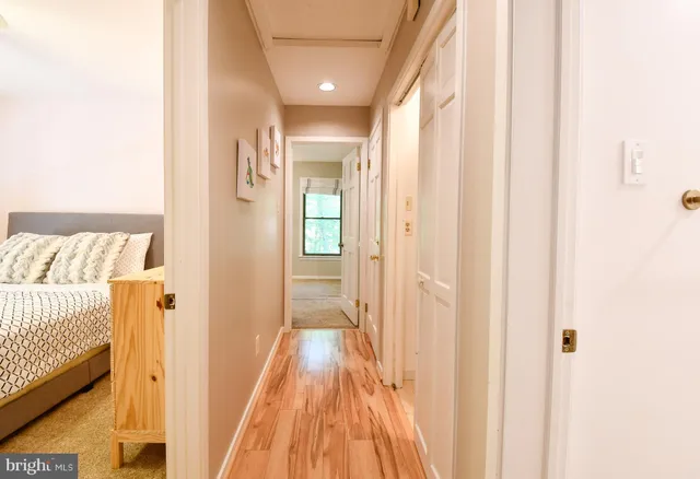 a living room with furniture a refrigerator and a table