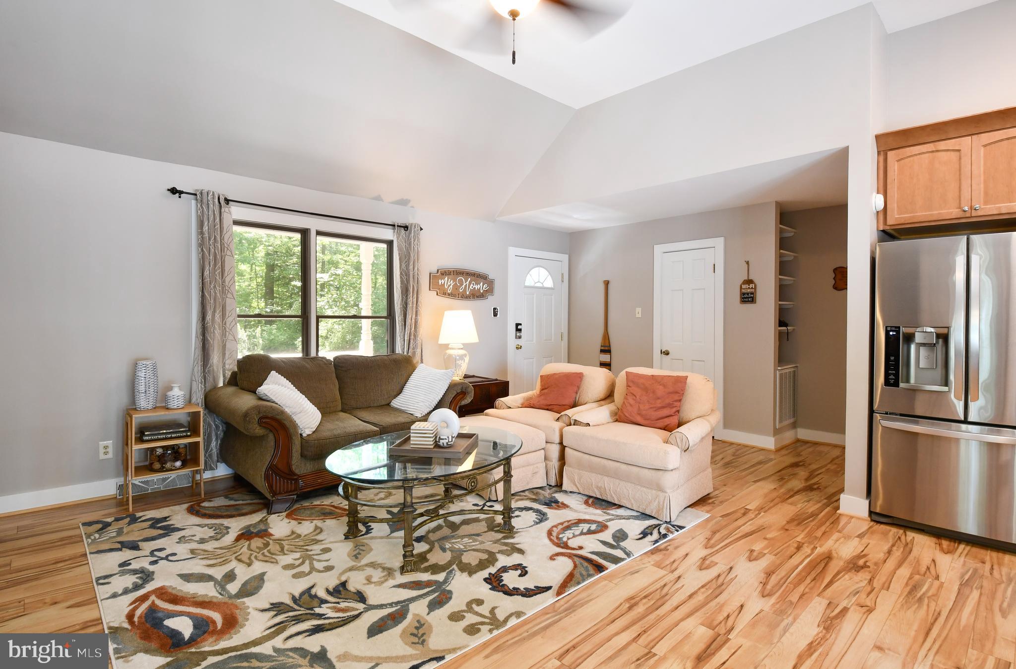 35 Tomahawk Circle Mineral, VA 23117 - Photo 16 of 25 a living room with furniture a refrigerator and a table