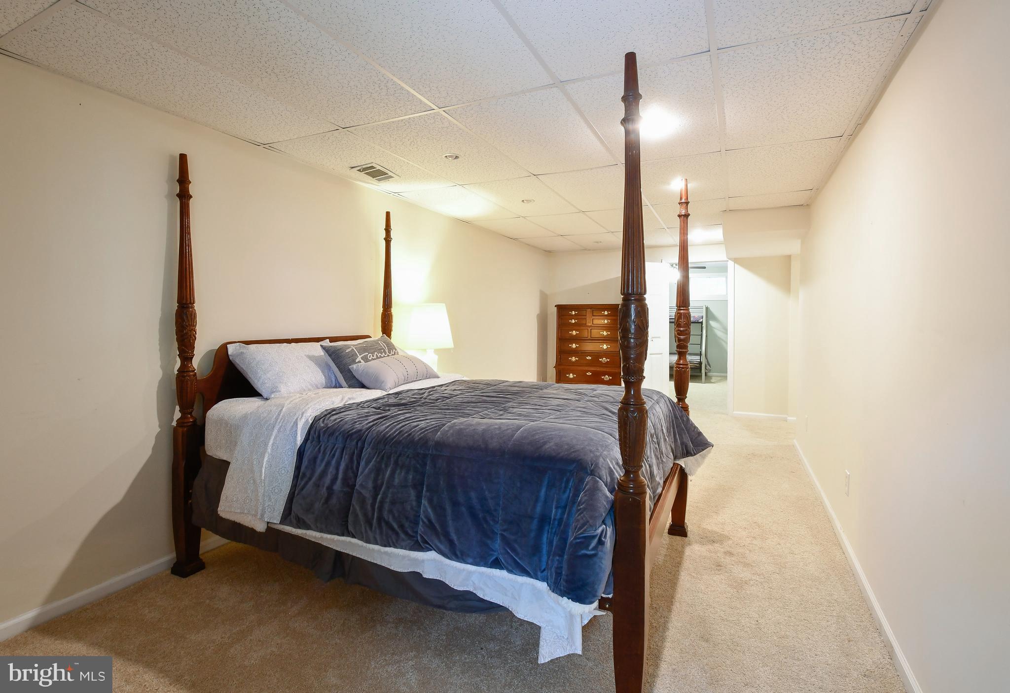 35 Tomahawk Circle Mineral, VA 23117 - Photo 21 of 25 a bedroom with a large bed and a chandelier