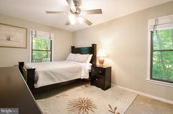 a bedroom with a bed and a mirror on dresser