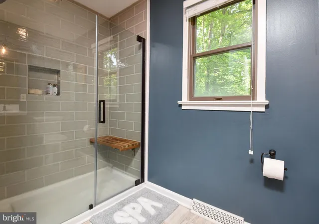 a spacious bathroom with a double vanity sink and a mirror