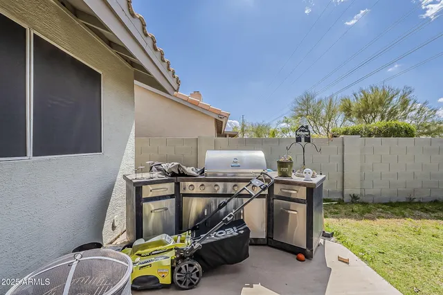 a view of a patio with a table and chairs