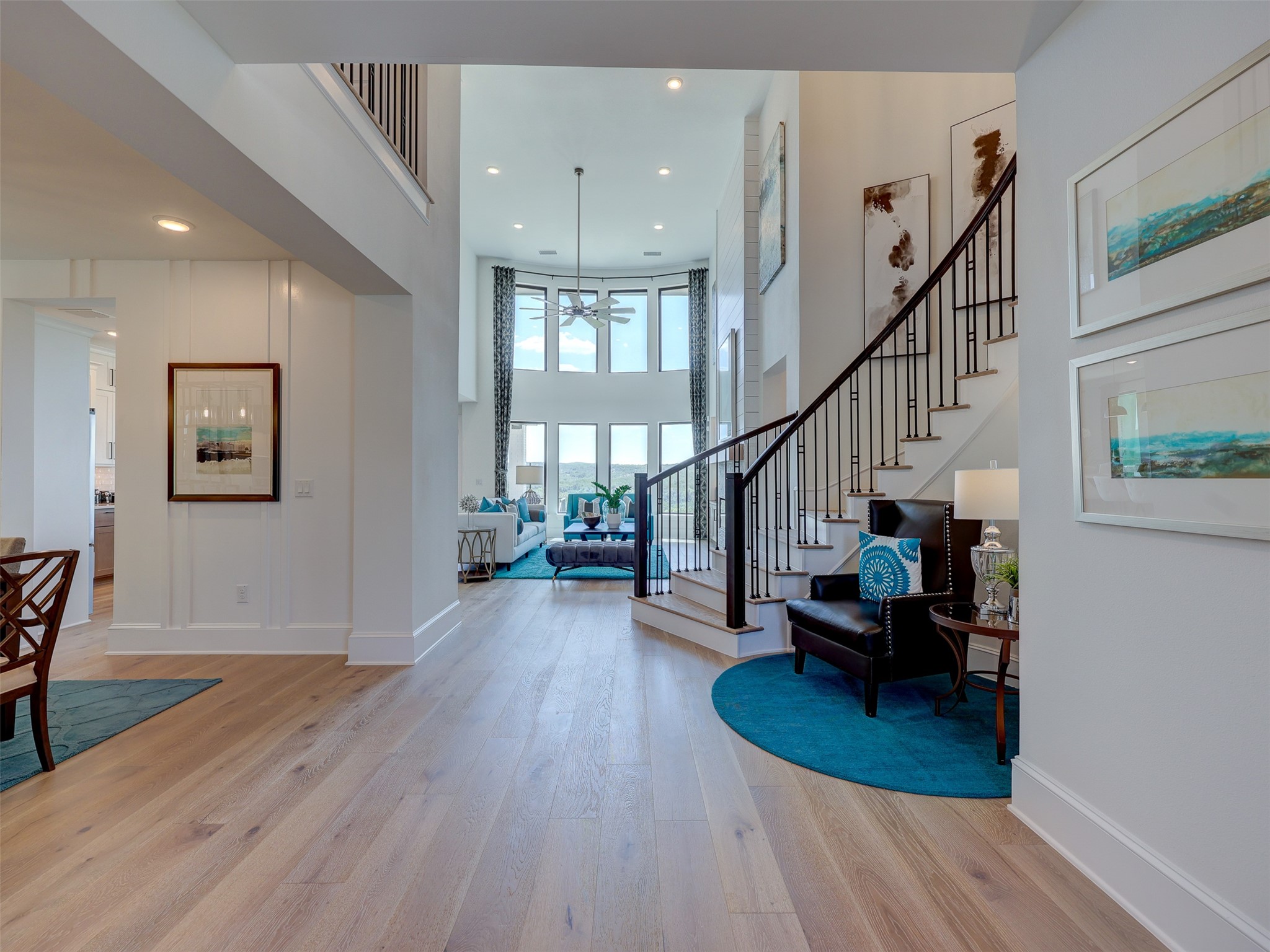 6220 Bower Well Road Austin, TX 78738 - Photo 4 of 28 A grand entrance with high ceilings and an open-concept living space, illuminated by expansive windows.