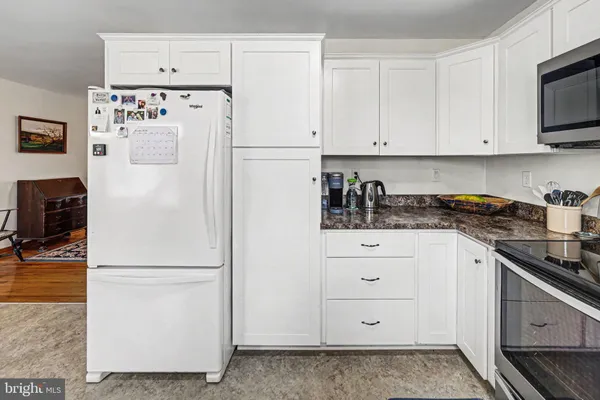 a white refrigerator freezer sitting in a kitchen