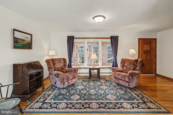 a living room with furniture rug and window