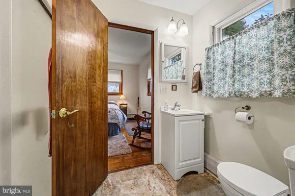 a bathroom with a sink a toilet and shower curtain