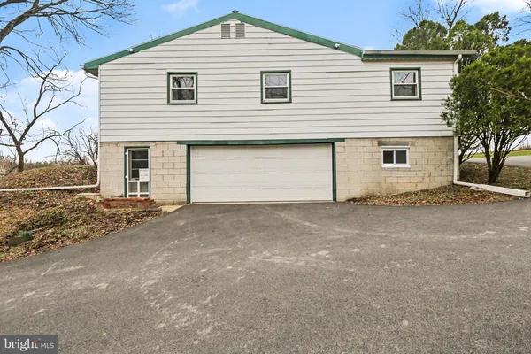 a view of garage yard and front view of a house