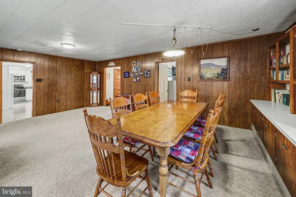 a dining room with a wooden table and chairs