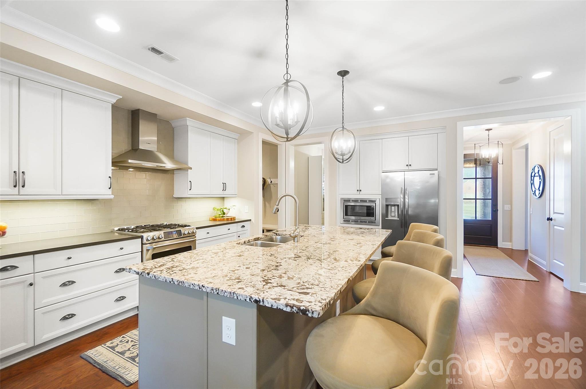 8614 Preserve Pond Road Cornelius, NC 28031 - Photo 12 of 48 a kitchen with stainless steel appliances granite countertop a sink a stove and a refrigerator