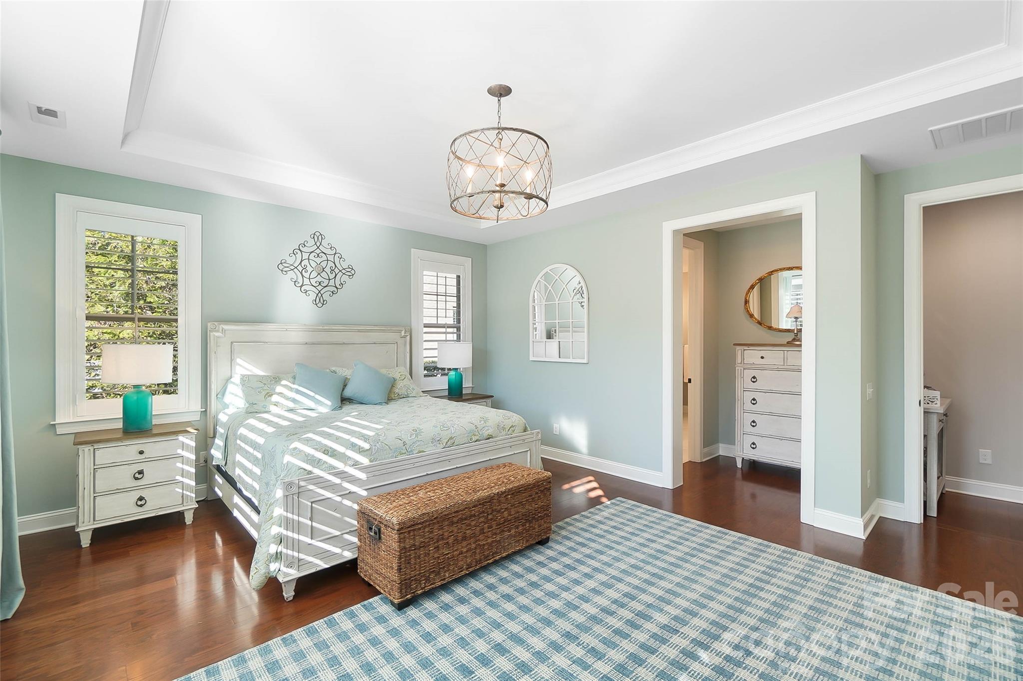 8614 Preserve Pond Road Cornelius, NC 28031 - Photo 25 of 48 a bedroom with a bed and a table in it with wooden floor