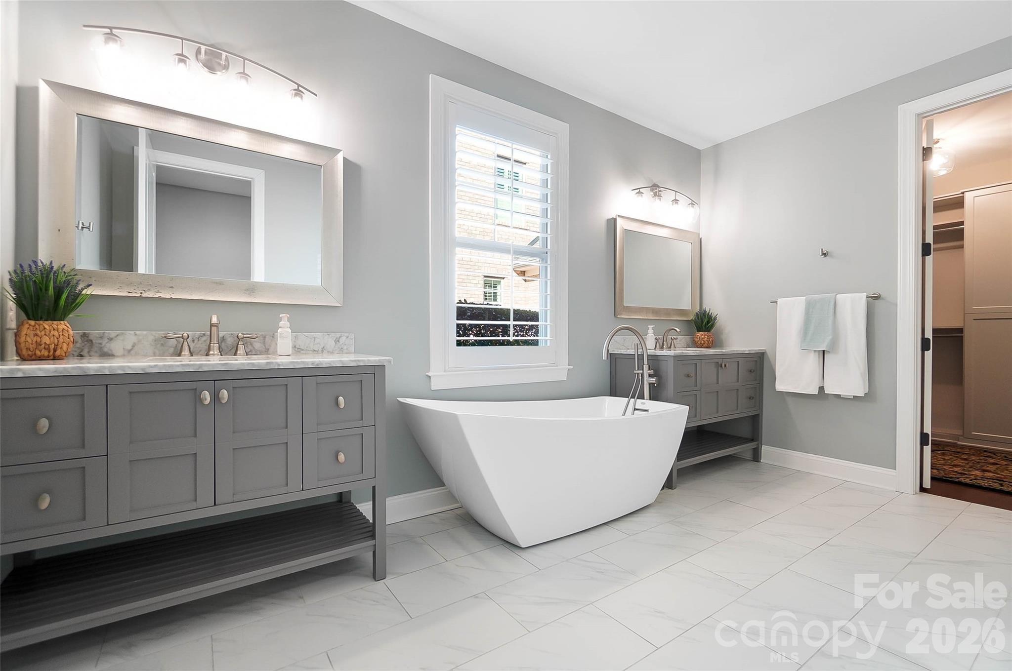 8614 Preserve Pond Road Cornelius, NC 28031 - Photo 27 of 48 a bathroom with a tub sink and mirror