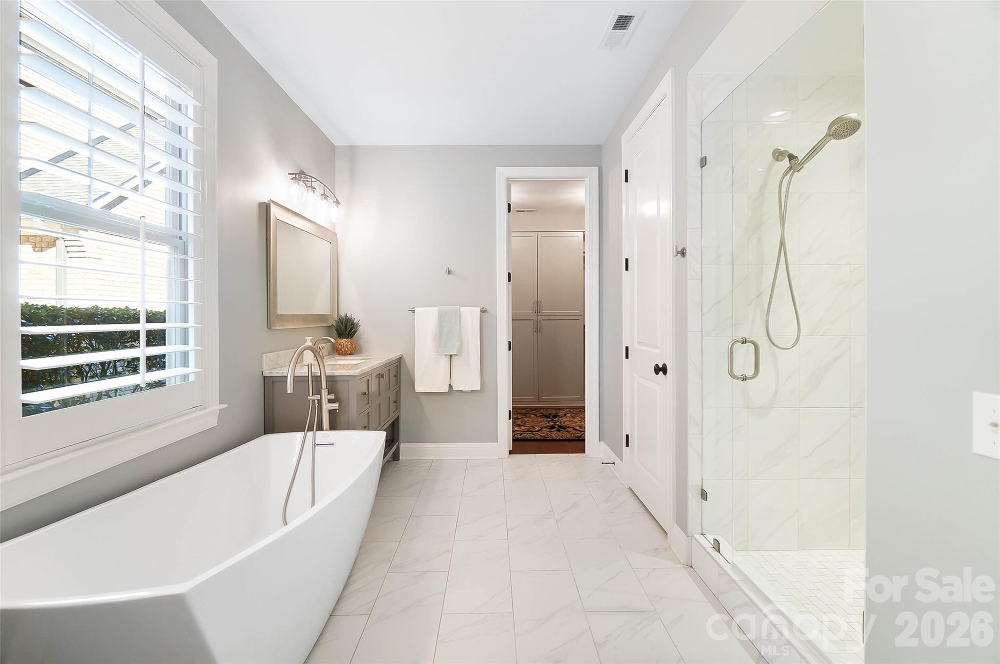 8614 Preserve Pond Road Cornelius, NC 28031 - Photo 28 of 48 a spacious bathroom with a tub shower and windows