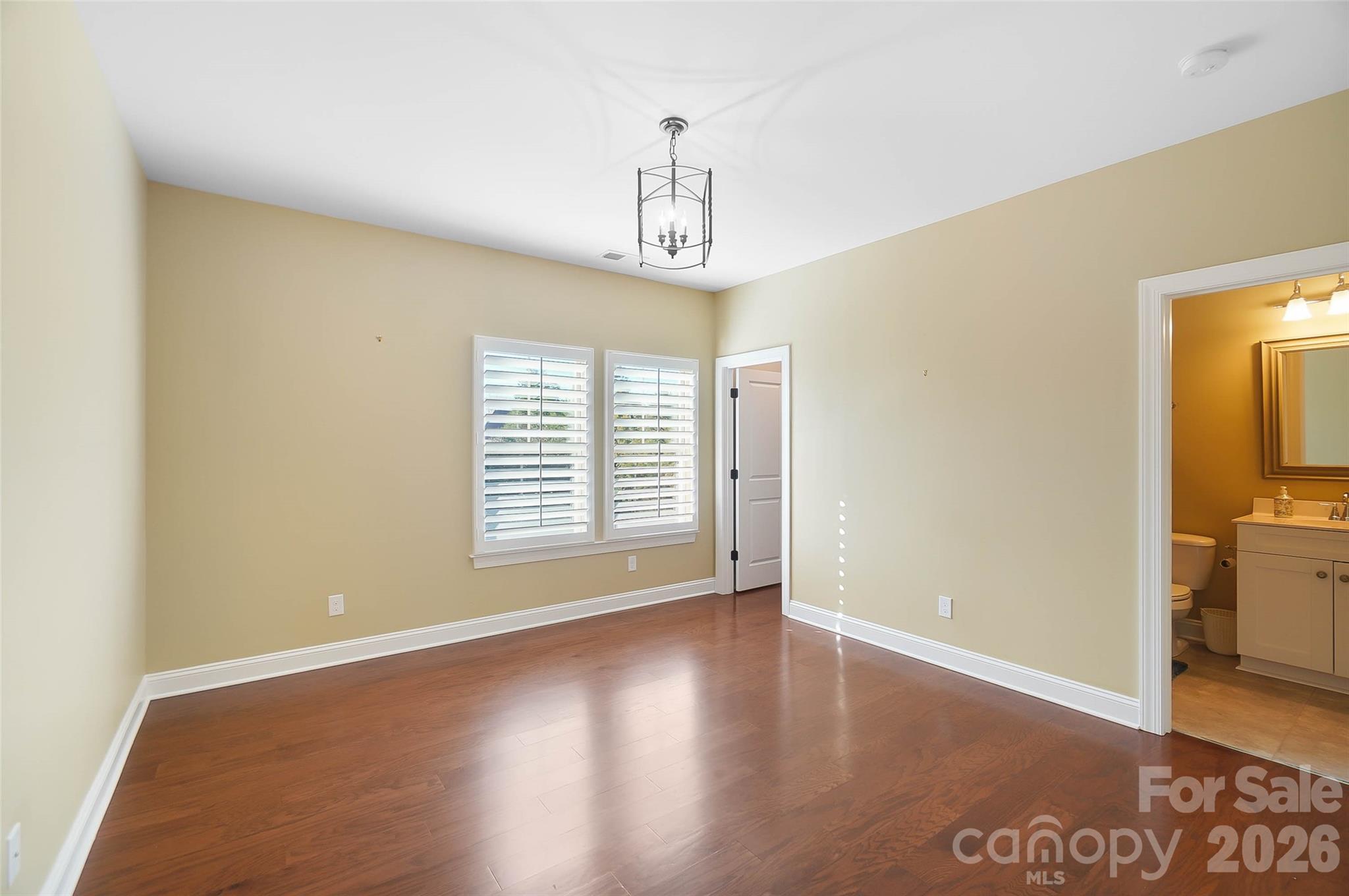 8614 Preserve Pond Road Cornelius, NC 28031 - Photo 32 of 48 a view of an empty room with window and wooden floor