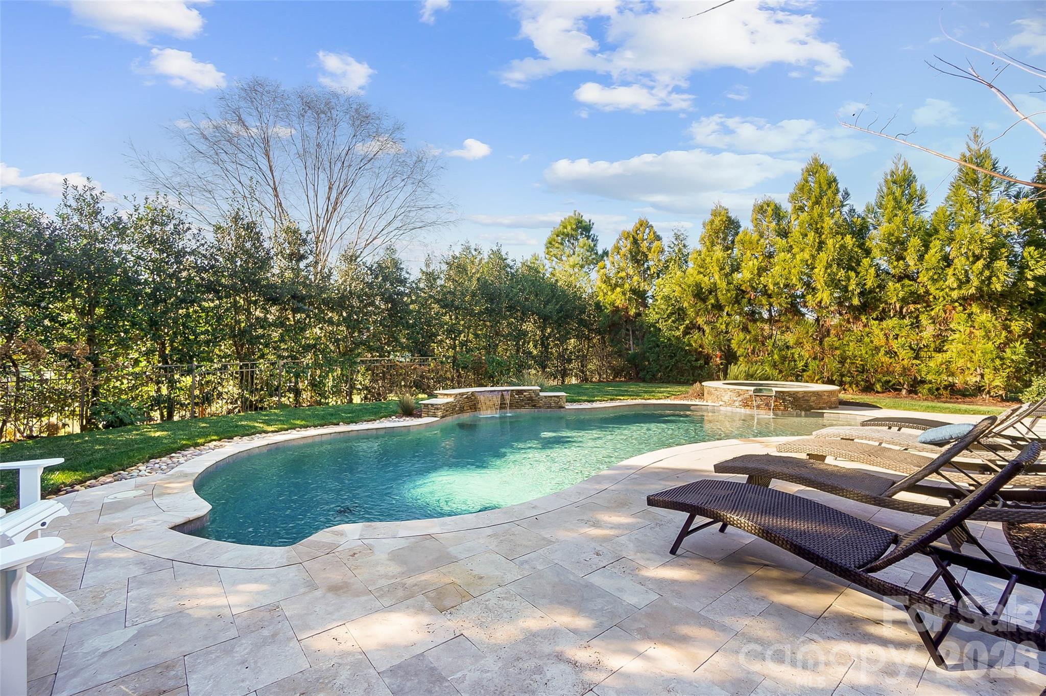 8614 Preserve Pond Road Cornelius, NC 28031 - Photo 42 of 48 a view of a lake with a bench and trees in the background