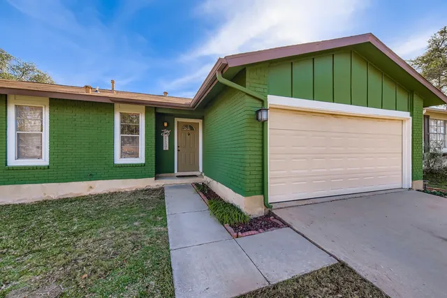 a view of empty room with wooden floor and fireplace