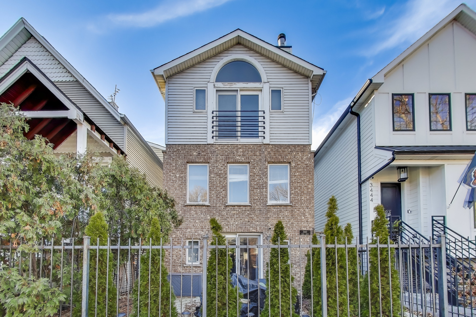 3442 North Damen Avenue, Unit 3 Chicago, IL 60618 - Photo 1 of 34 a front view of a house with wooden fence