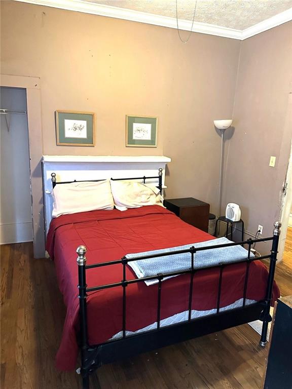 111 Griffin Street Northwest Atlanta, GA 30314 - Photo 2 of 9 a bedroom with a bed table and chair