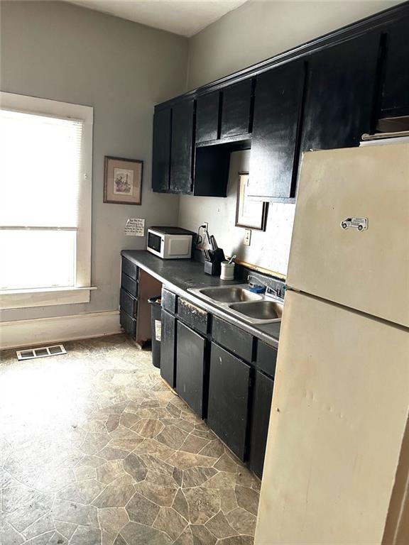 111 Griffin Street Northwest Atlanta, GA 30314 - Photo 6 of 9 a kitchen with a sink a stove and refrigerator