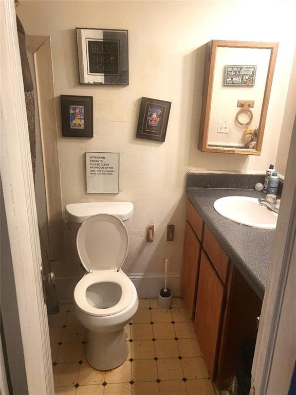 111 Griffin Street Northwest Atlanta, GA 30314 - Photo 7 of 9 a white toilet sitting next to a bathroom sink and a mirror