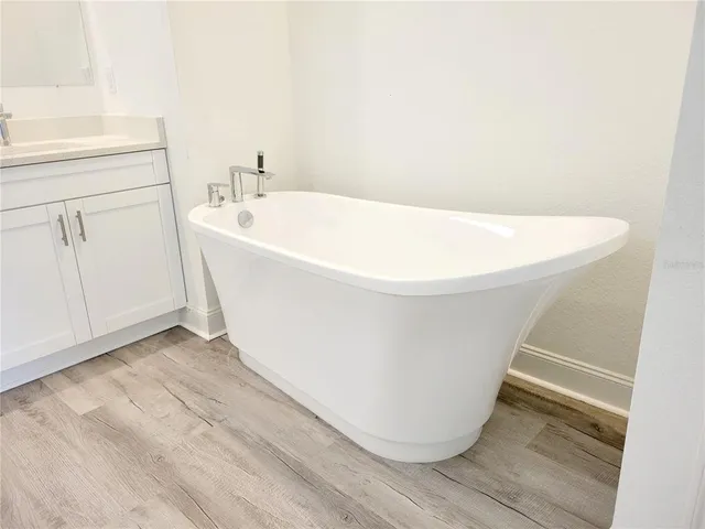 a white bath tub sitting in a bathroom