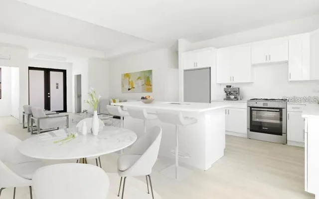 a kitchen with a sink counter and chairs