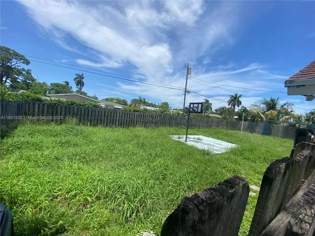 a backyard of a house with wooden fence