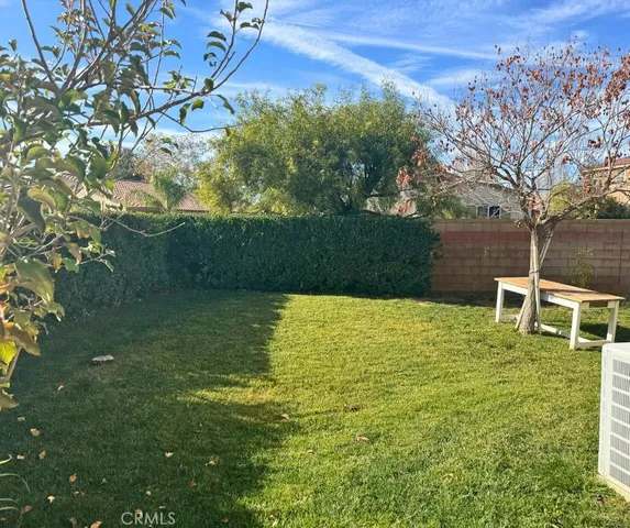 a blue swimming pool is in the middle of a garden