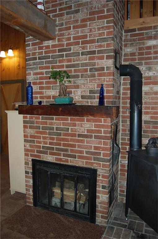 522 Shady Nook Road West Newfield, ME 04095 - Photo 11 of 30 Fireplace w/ wood stove on brick hearth.