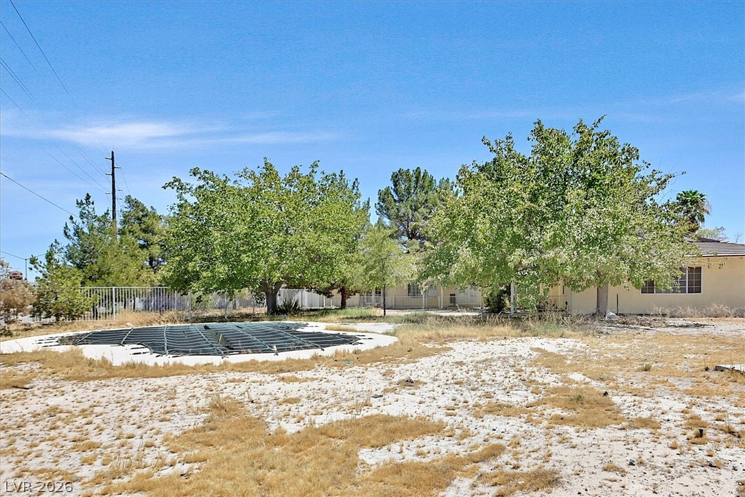 3618 Fieldcrest Road Las Vegas, NV 89121 - Photo 33 of 36 A private yard with mature trees offers ample space for outdoor activities, complementing the covered pool.