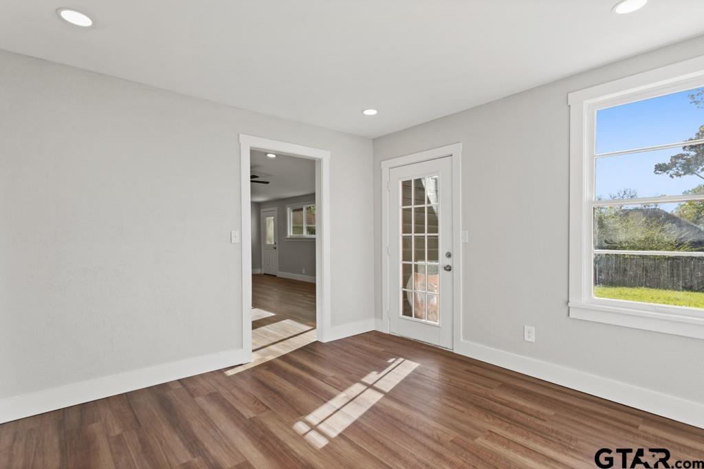 2819 New Copeland Road Tyler, TX 75701 - Photo 17 of 39 a view of an empty room with wooden floor and a window