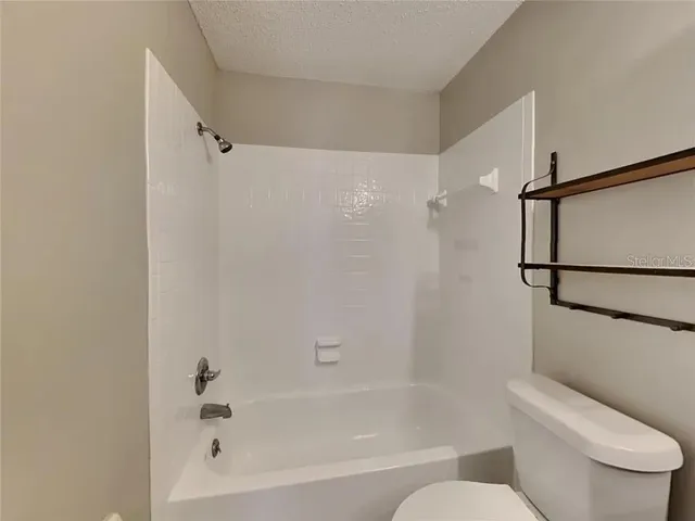 a bathroom with a toilet and a bathtub