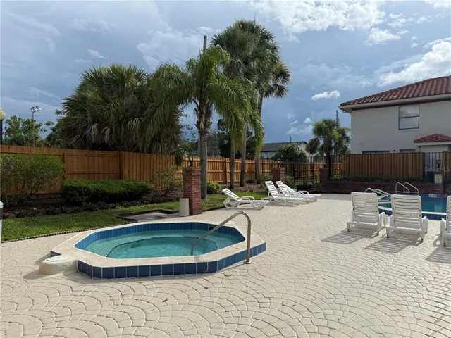 a view of a swimming pool with a patio