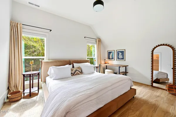 a bedroom with a bed and a large window