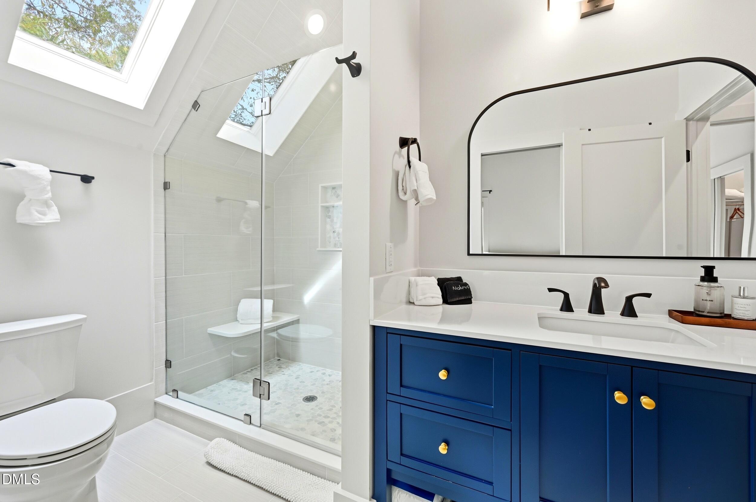 1459 Hawkins Road Hurdle Mills, NC 27541 - Photo 16 of 36 a bathroom with a sink a toilet and shower