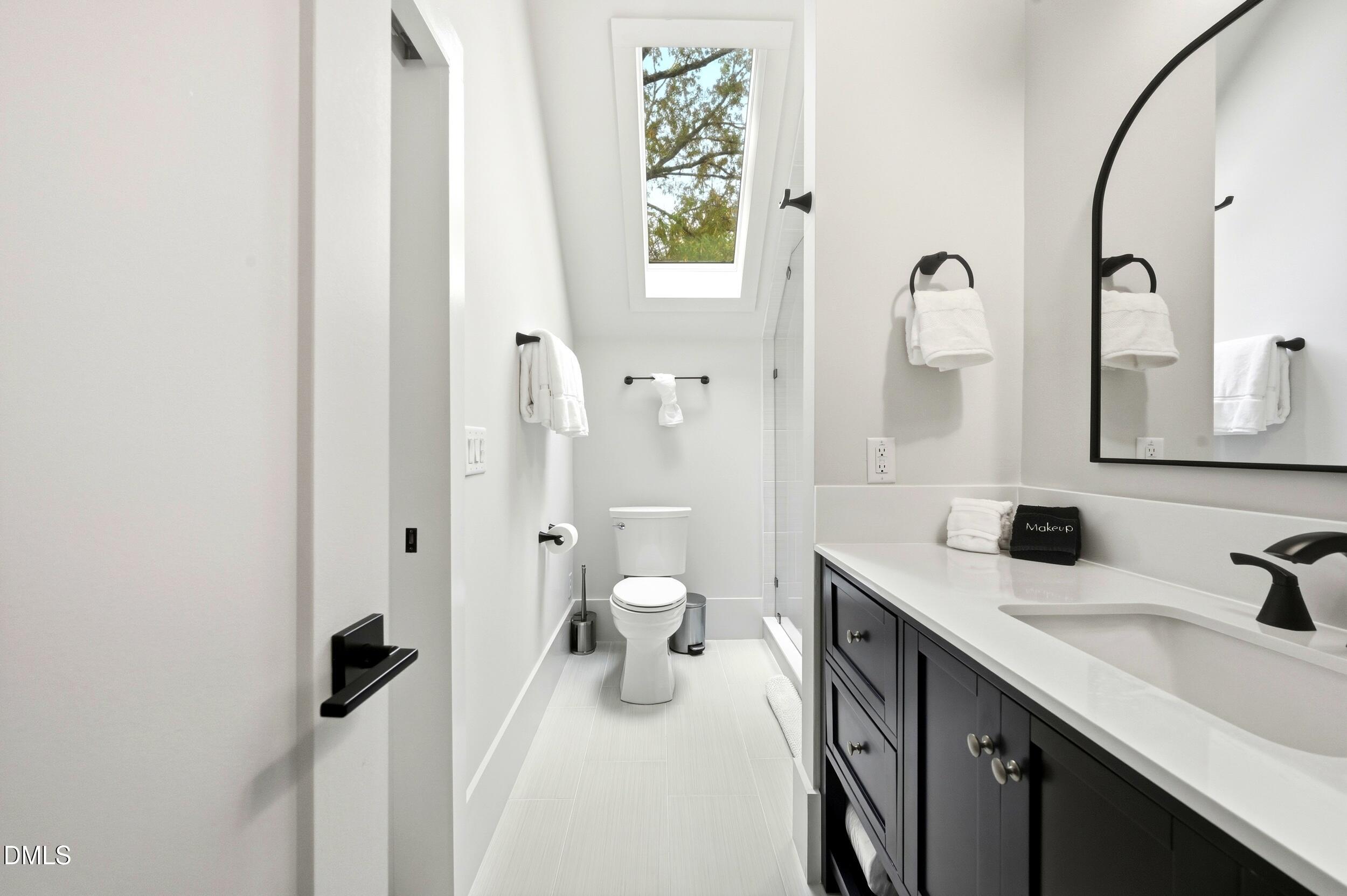 1459 Hawkins Road Hurdle Mills, NC 27541 - Photo 18 of 36 a bathroom with a sink and mirror with toilet