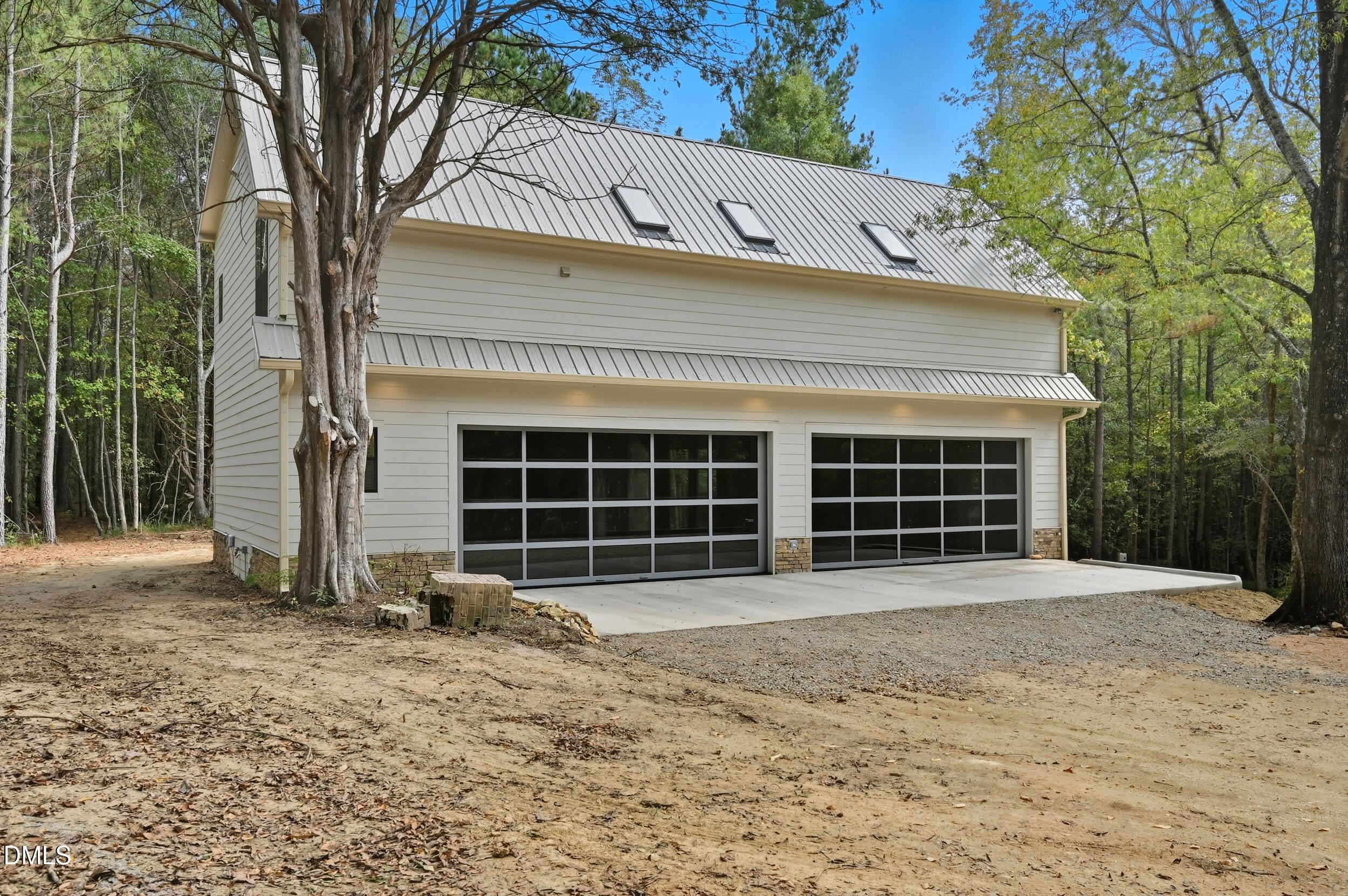 1459 Hawkins Road Hurdle Mills, NC 27541 - Photo 23 of 36 a front view of a house with a yard and garage