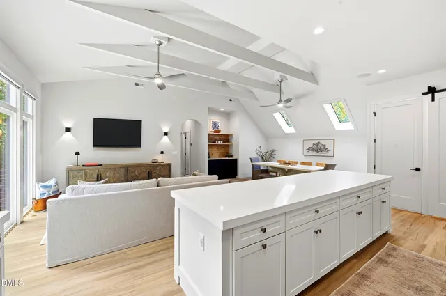 a kitchen with a stove and a wooden floor