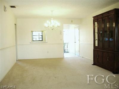 6916 Winkler Road Fort Myers, FL 33919 - Photo 5 of 10 en empty room with kitchen view