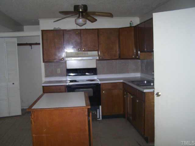 2717 Wyncote Drive Raleigh, NC 27603 - Photo 2 of 9 a kitchen with a stove and a microwave