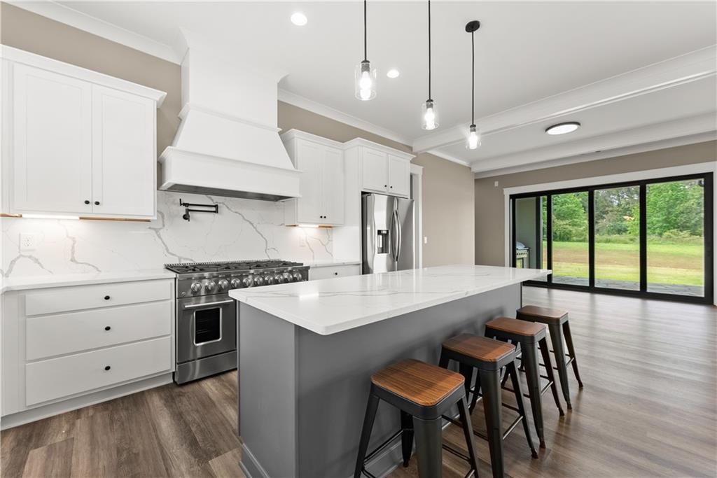 2275 Dr Bramblett Road Cumming, GA 30028 - Photo 20 of 78 a kitchen with a table chairs stove and wooden floor