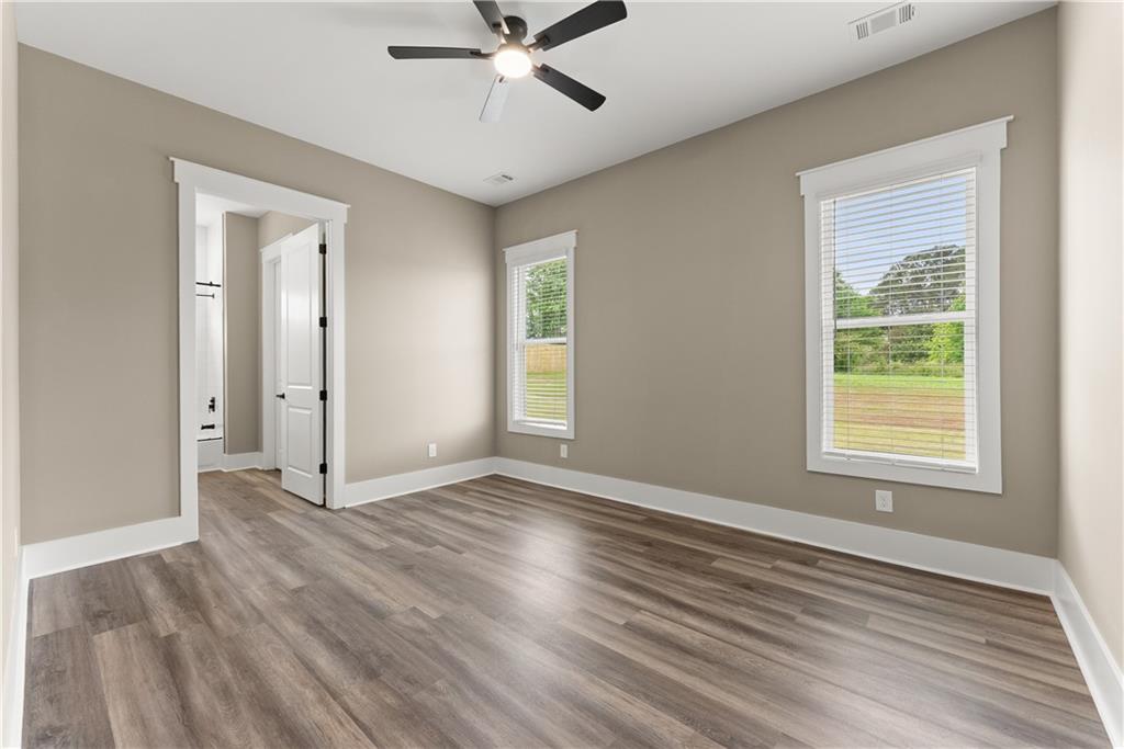2275 Dr Bramblett Road Cumming, GA 30028 - Photo 28 of 78 a view of an empty room with wooden floor and a window
