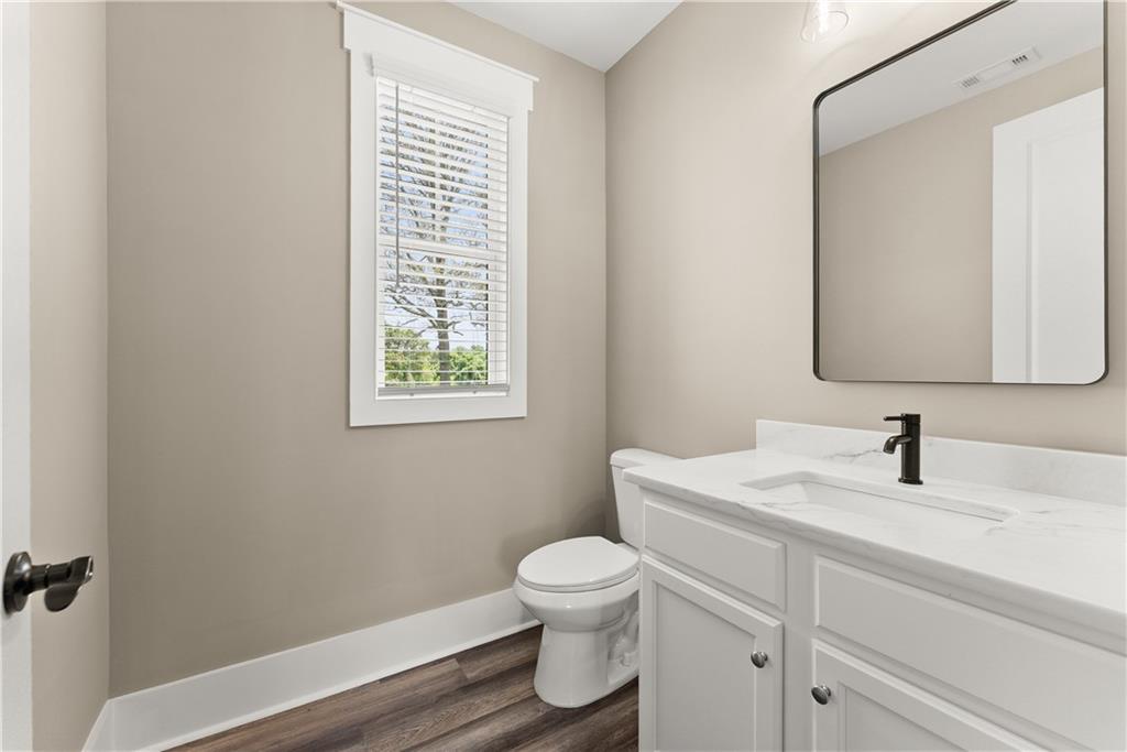 2275 Dr Bramblett Road Cumming, GA 30028 - Photo 33 of 78 a bathroom with a toilet a sink and a mirror