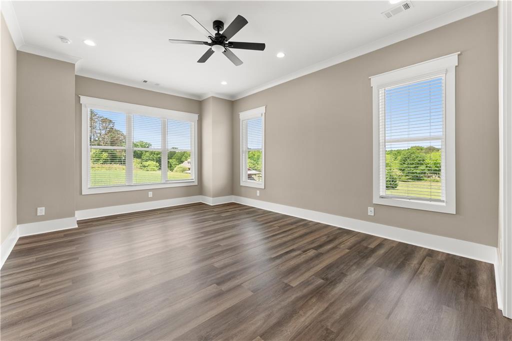 2275 Dr Bramblett Road Cumming, GA 30028 - Photo 34 of 78 a view of empty room with wooden floor and fan