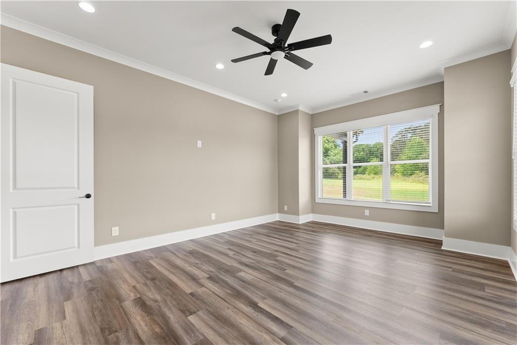 2275 Dr Bramblett Road Cumming, GA 30028 - Photo 36 of 78 a view of empty room with wooden floor and fan