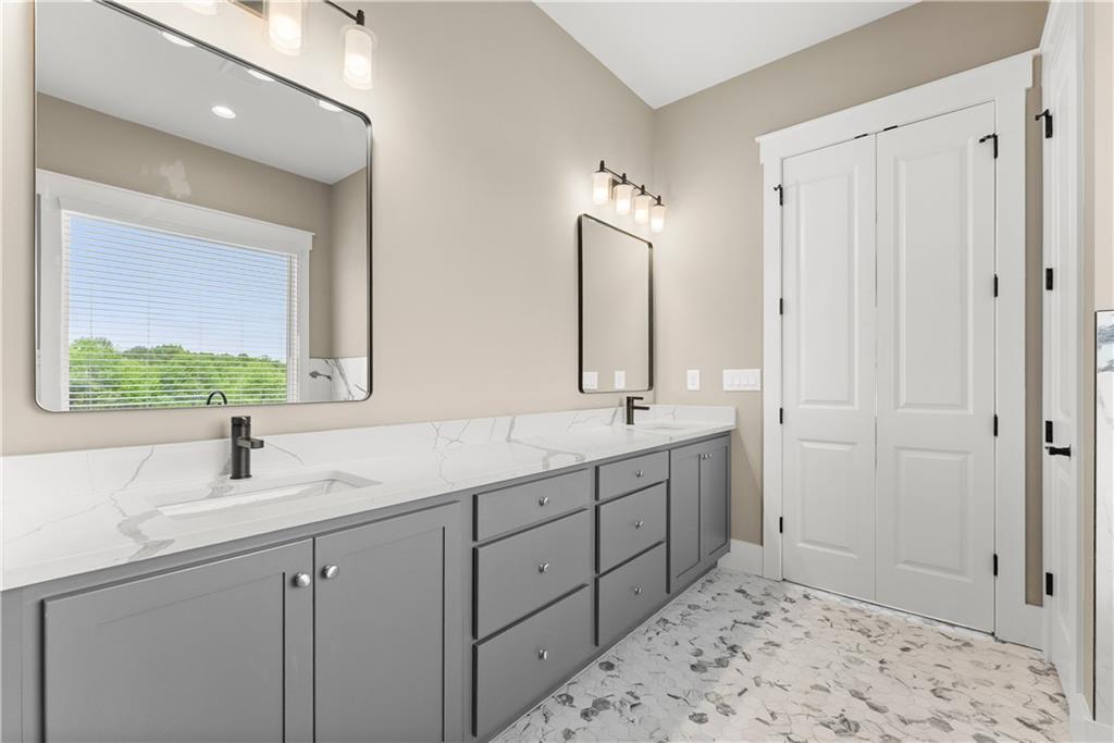2275 Dr Bramblett Road Cumming, GA 30028 - Photo 39 of 78 a bathroom with a double vanity sink and mirror
